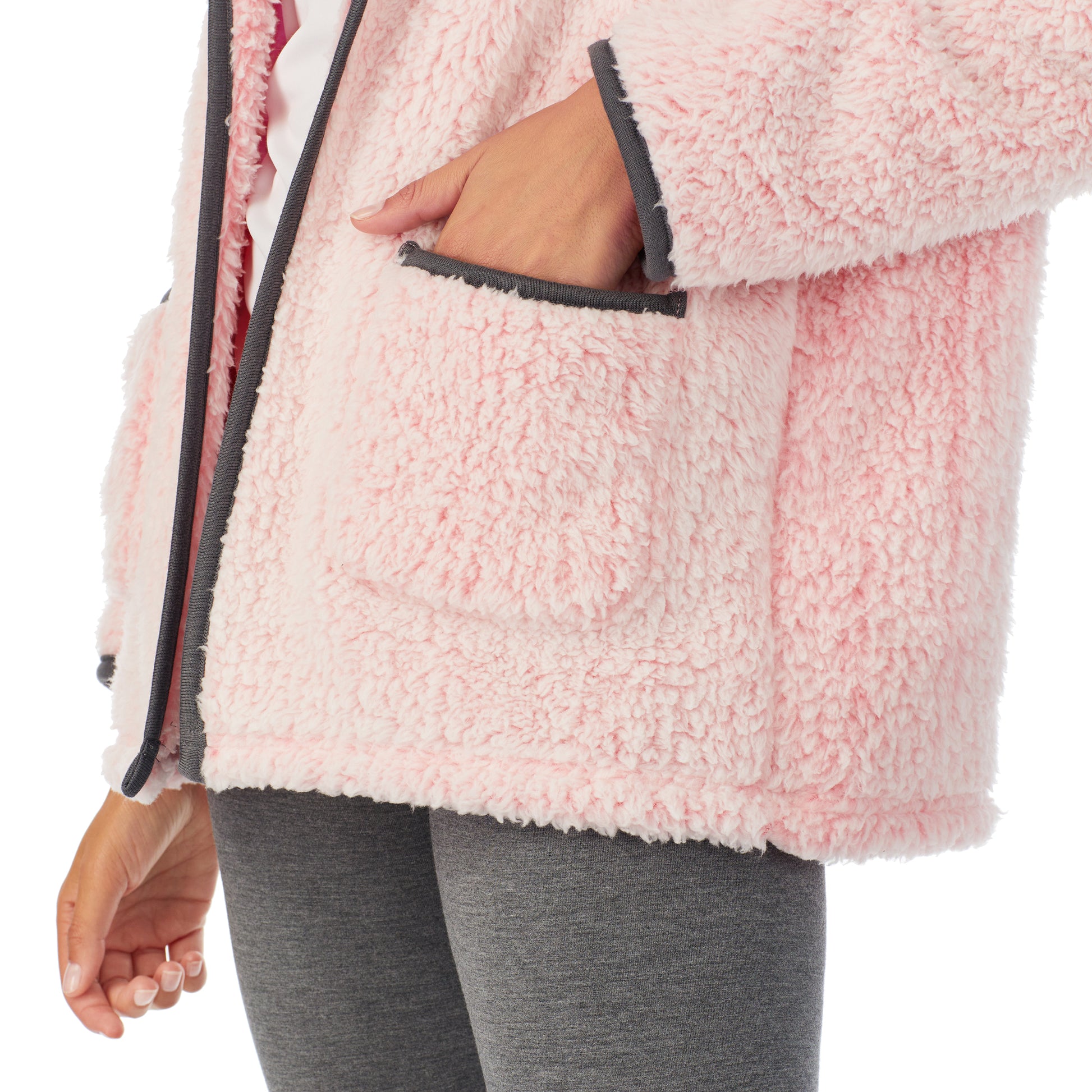 A lady wearing pink sherpa cardi