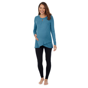 A lady wearing a bright coral long sleeve maternity wrap front top. #Model is wearing a maternity bump.