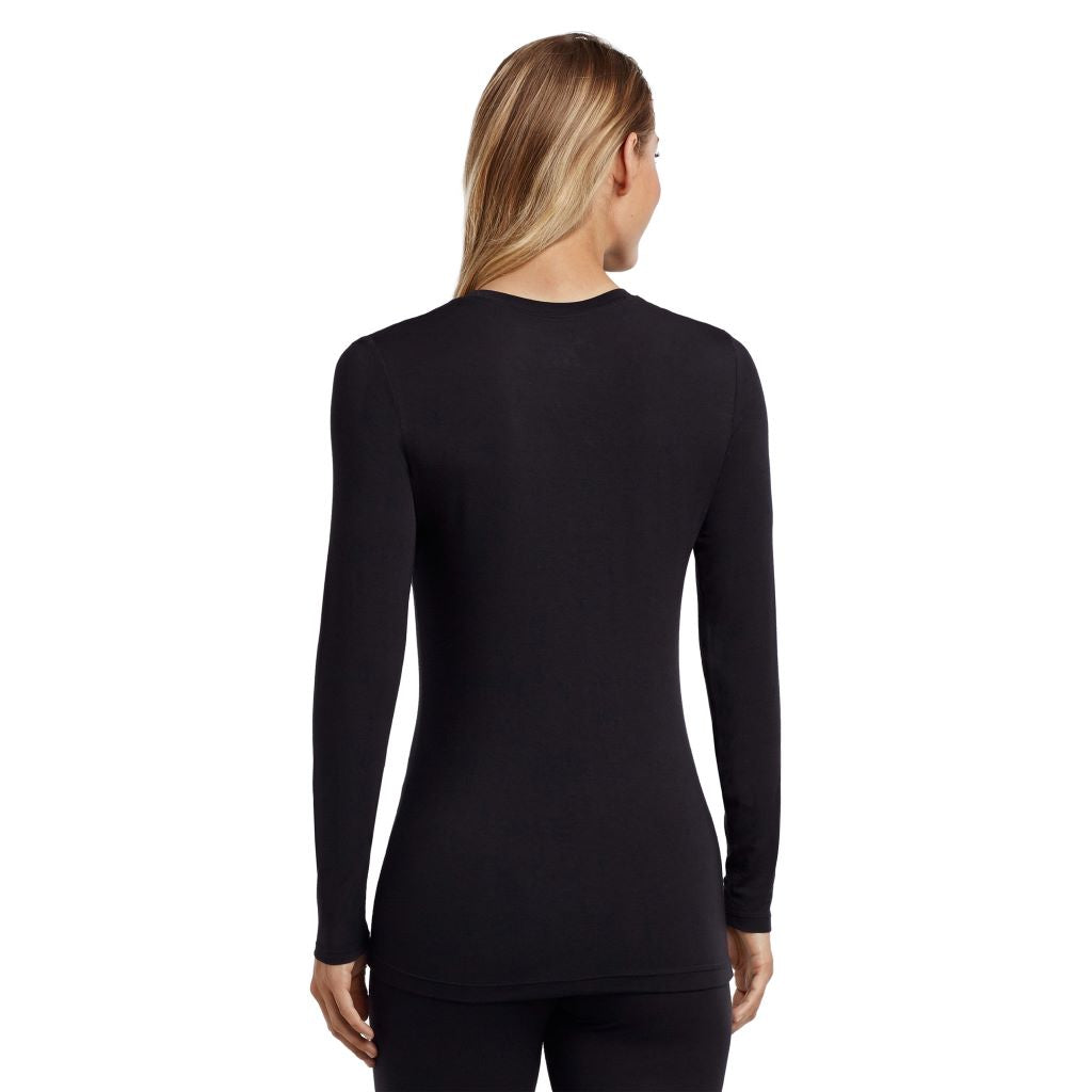A lady wearing a black long sleeve stretch crew. 