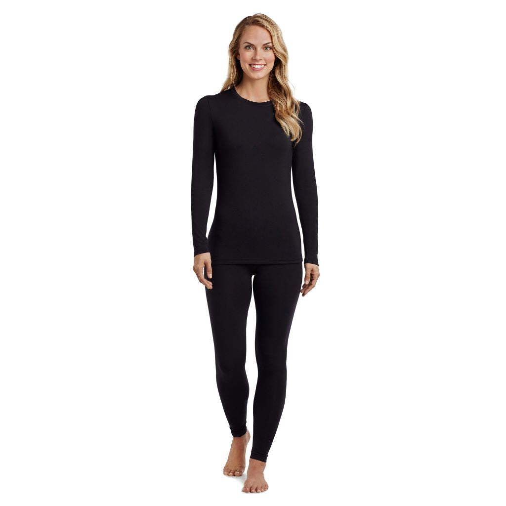 A lady wearing a black long sleeve stretch crew. 
