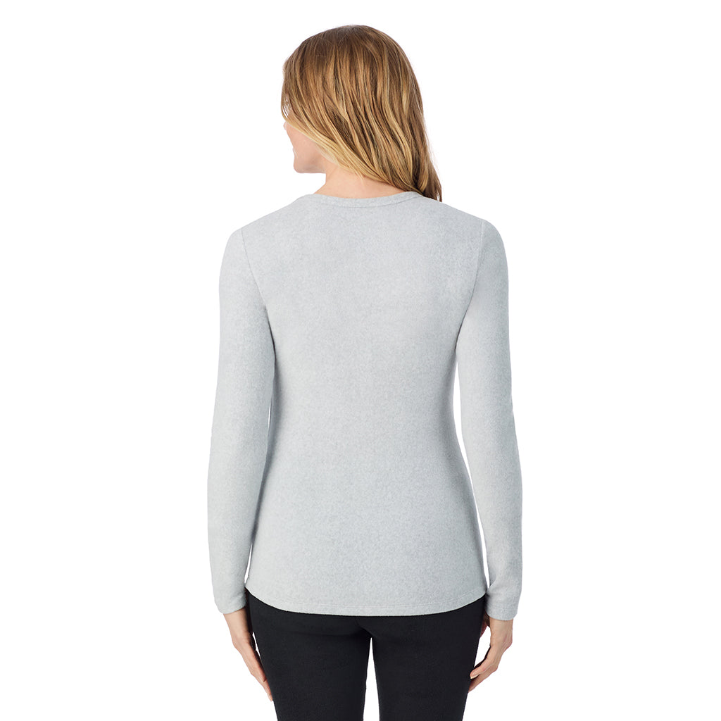 A lady wearing light grey heather long sleeve crew