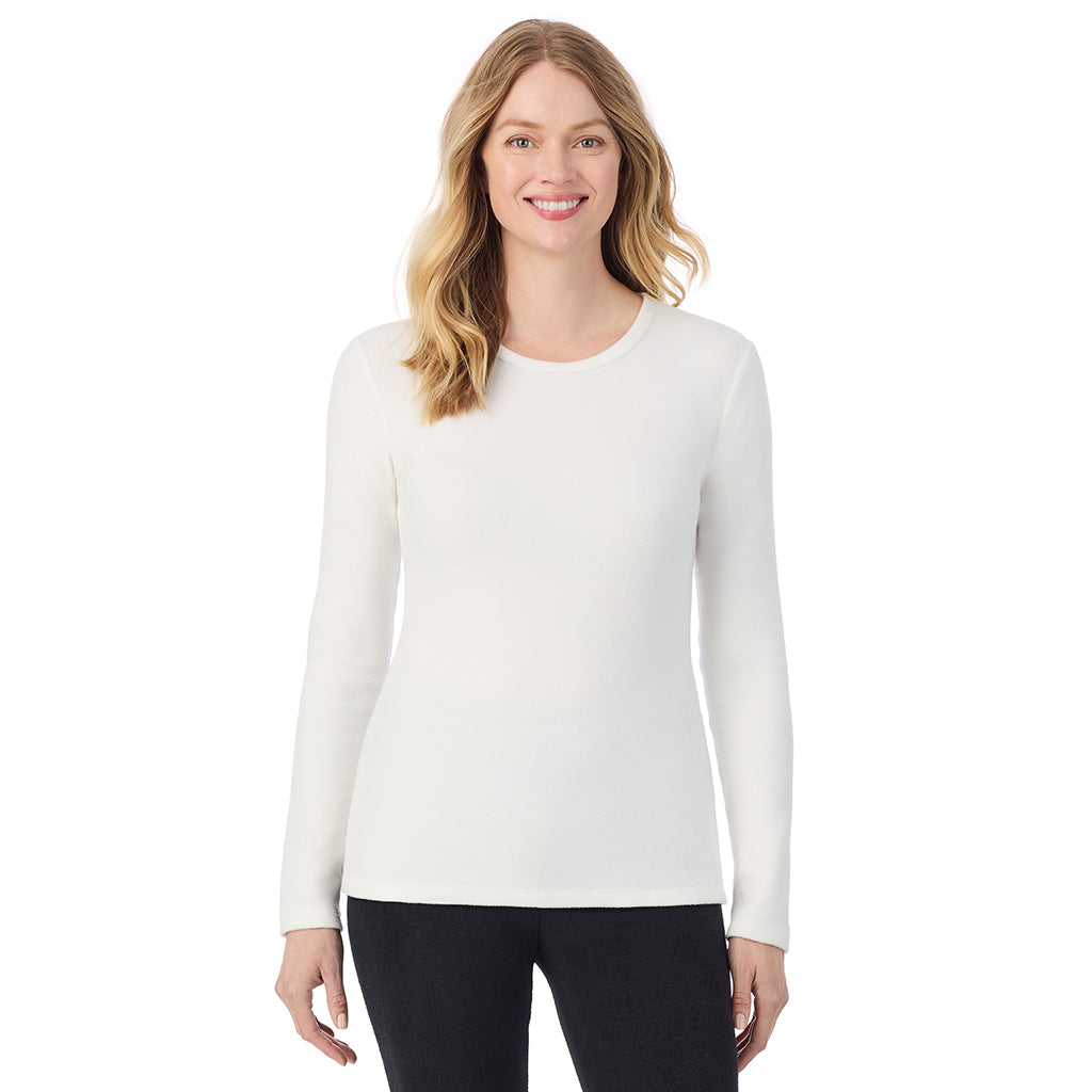 A lady wearing off white long sleeve crew