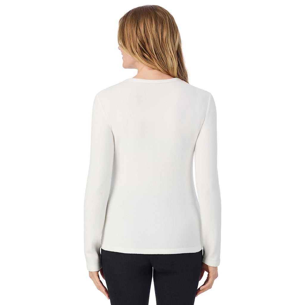 A lady wearing off white long sleeve crew