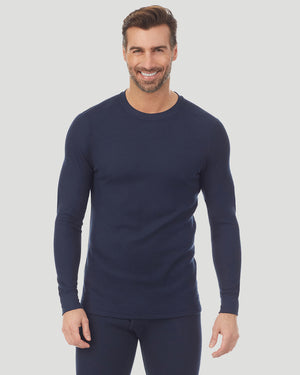 A man wearing a navy waffle thermal long sleeve crew.