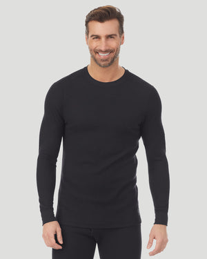 A man wearing a black waffle thermal long sleeve crew.