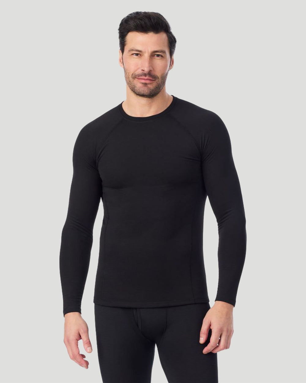 A man wearing a black X fleece long sleeve crew front pose