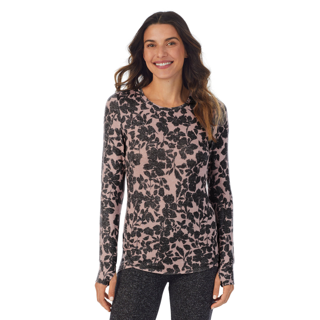 A lady wearing a Mauve floral long sleeve crew.