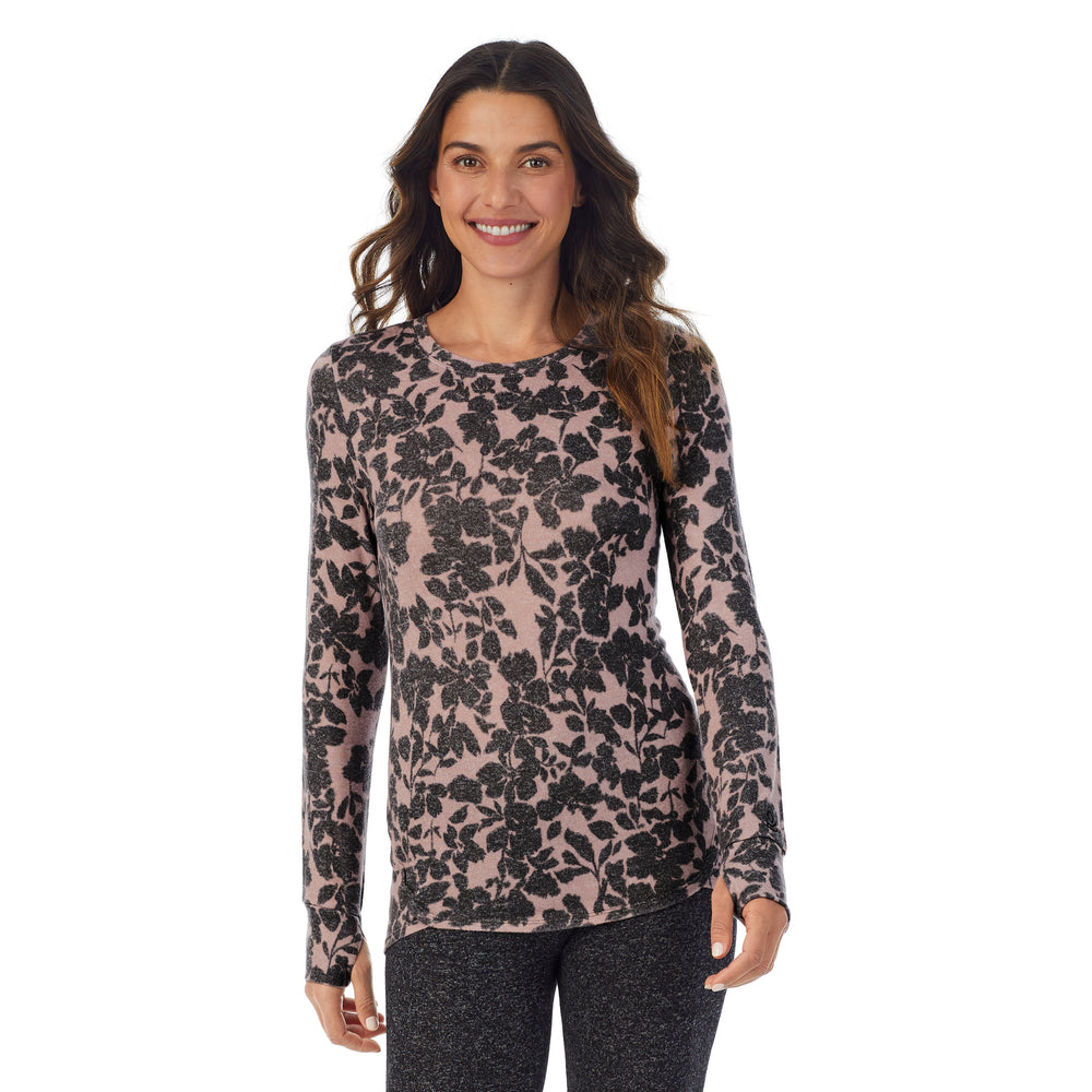 A lady wearing a Mauve floral long sleeve crew.