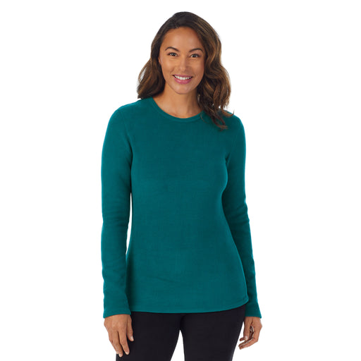 Teal Lagoon; Model is wearing size S. She is 5’8”, Bust 34”, Waist 24.5”, Hips 35”.@Upper body of a lady wearing Teal Lagoon long sleeve crew