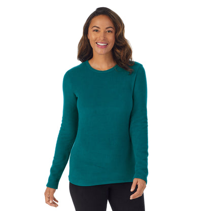 Teal Lagoon; Model is wearing size S. She is 5’8”, Bust 34”, Waist 24.5”, Hips 35”.@Upper body of a lady wearing Teal Lagoon long sleeve crew