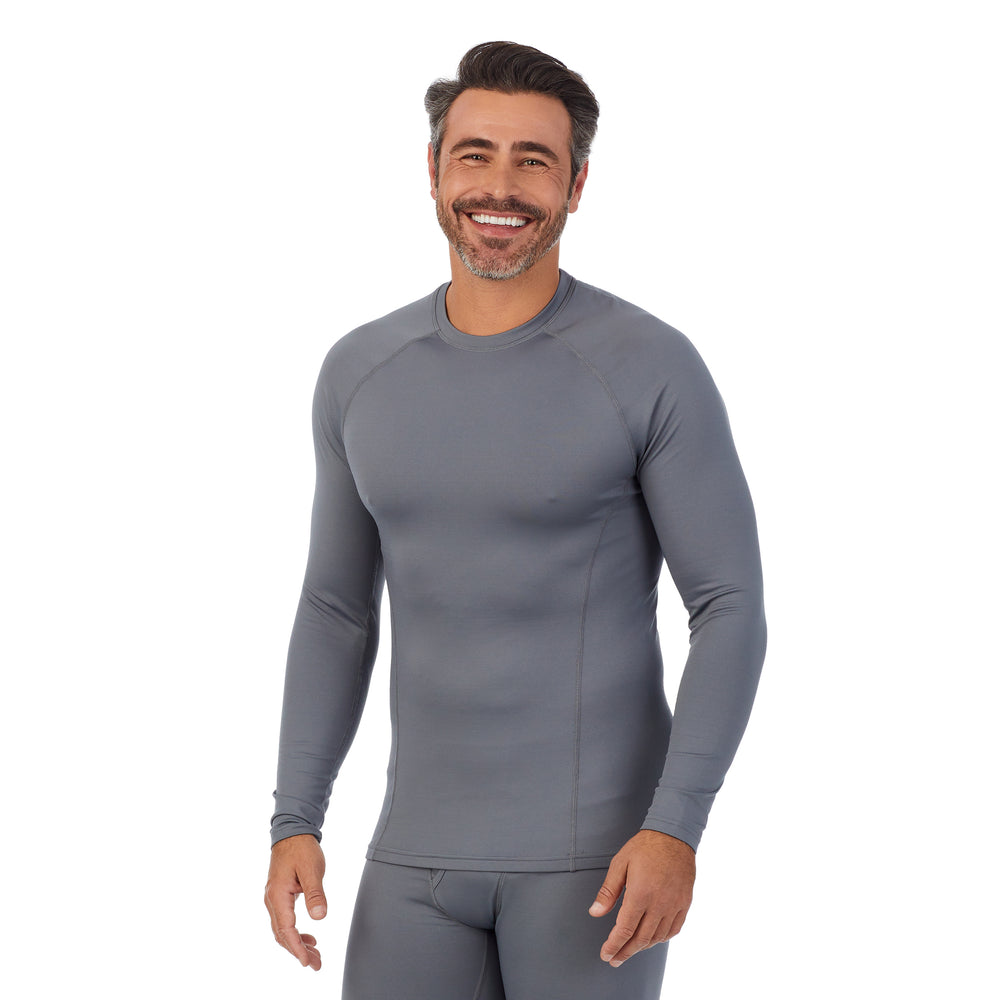 A man wearing nickel grey arcticore long sleeve crew. !88% Polyester, 12% Spandex!