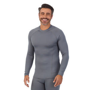 A man wearing nickel grey arcticore long sleeve crew. !88% Polyester, 12% Spandex!