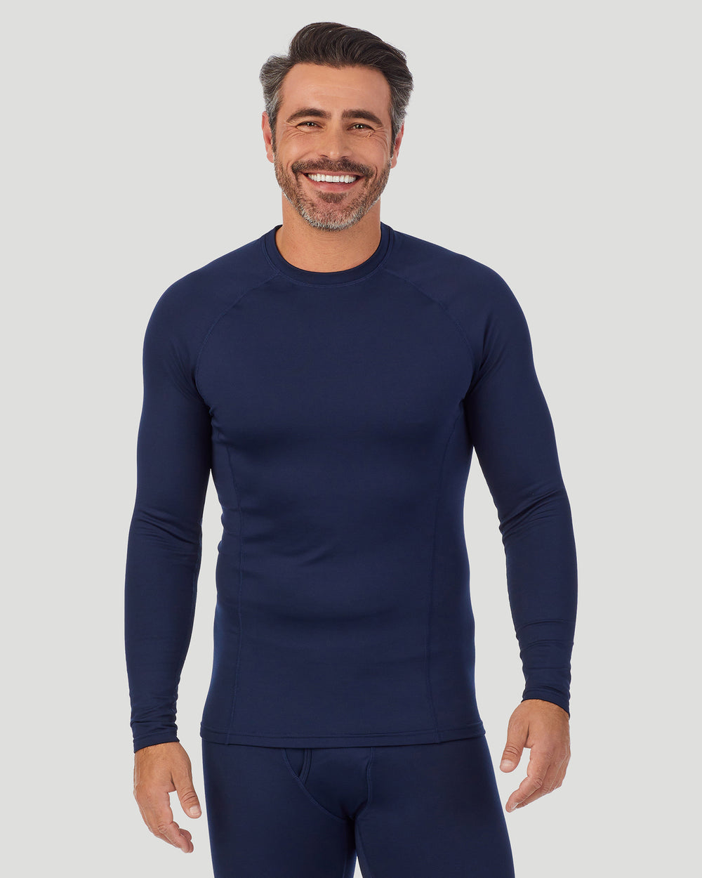 A man wearing navy blazer arcticore long sleeve crew. !88% Recycled Polyester, 12% Spandex!