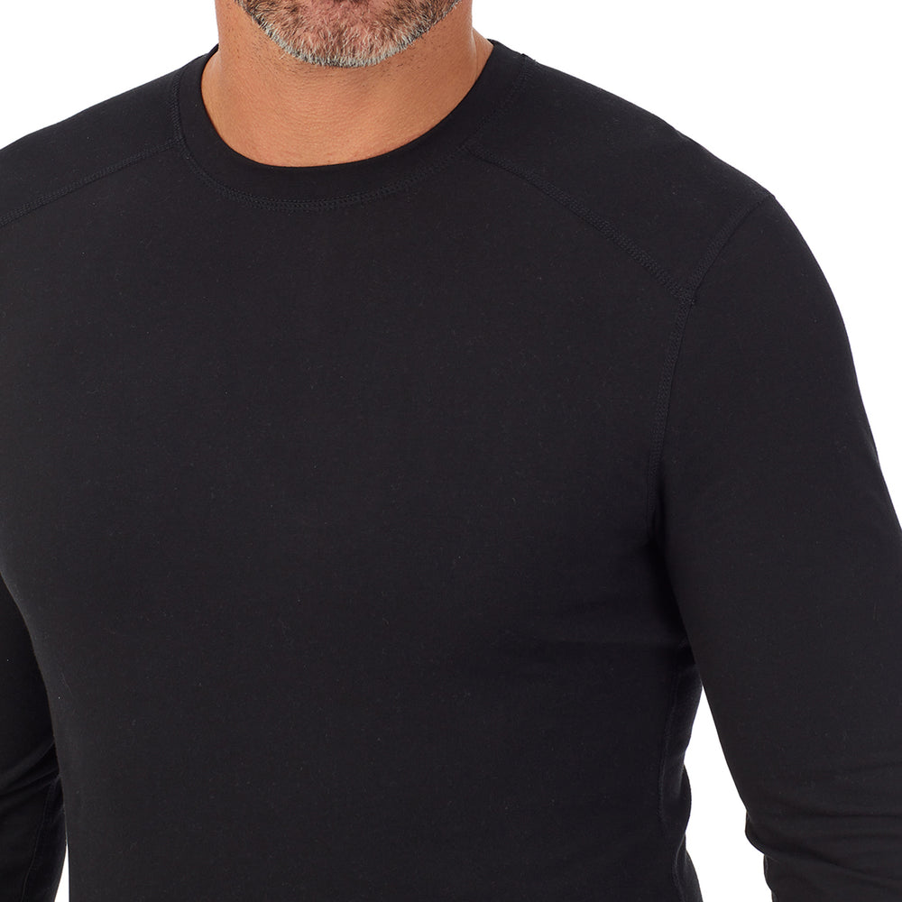 A man wearing a black long sleeve crew