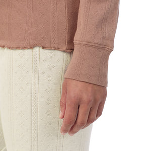 A lady is wearing Cotton Pointelle Long Sleeve Crew
