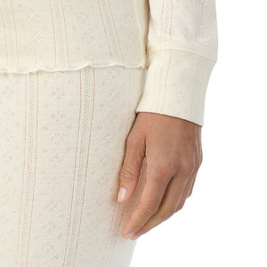 A lady is wearing Cotton Pointelle Long Sleeve Crew
