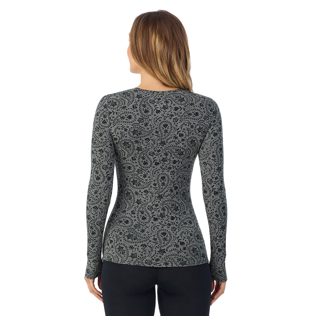 A lady wearing a charcoal paisley long sleeve stretch crew.