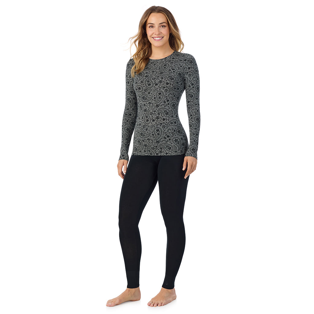 A lady wearing a charcoal paisley long sleeve stretch crew.
