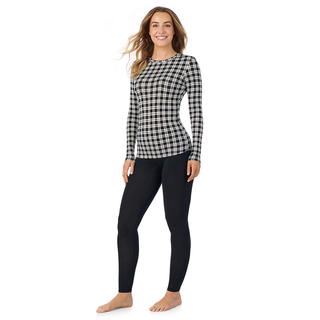 A lady wearing a ivory/black plaid long sleeve stretch crew.