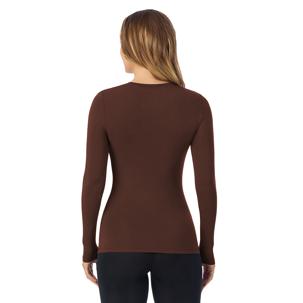 A lady wearing a deep mahogani long sleeve stretch crew.