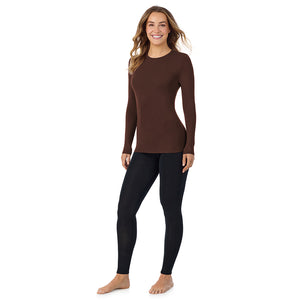 A lady wearing a deep mahogani long sleeve stretch crew.