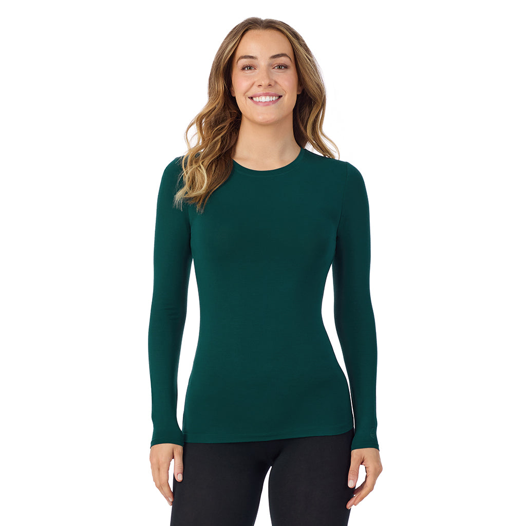 A lady wearing a dark pine long sleeve stretch crew tall.