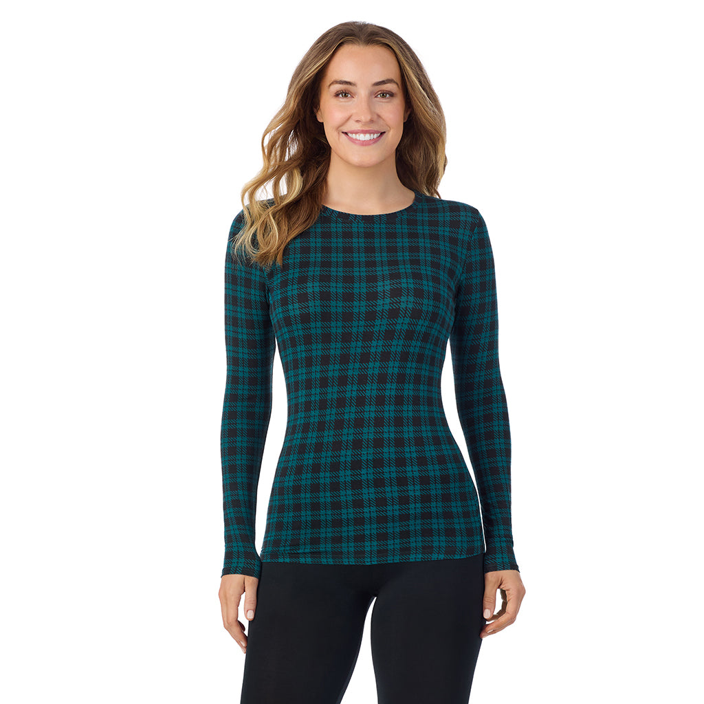 A lady wearing a dk pine/black plaid long sleeve stretch crew.