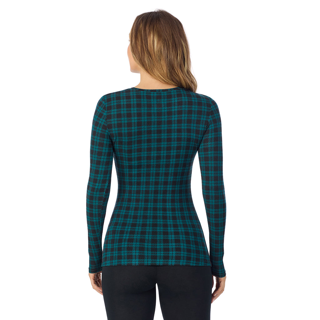 A lady wearing a dk pine/black plaid long sleeve stretch crew.