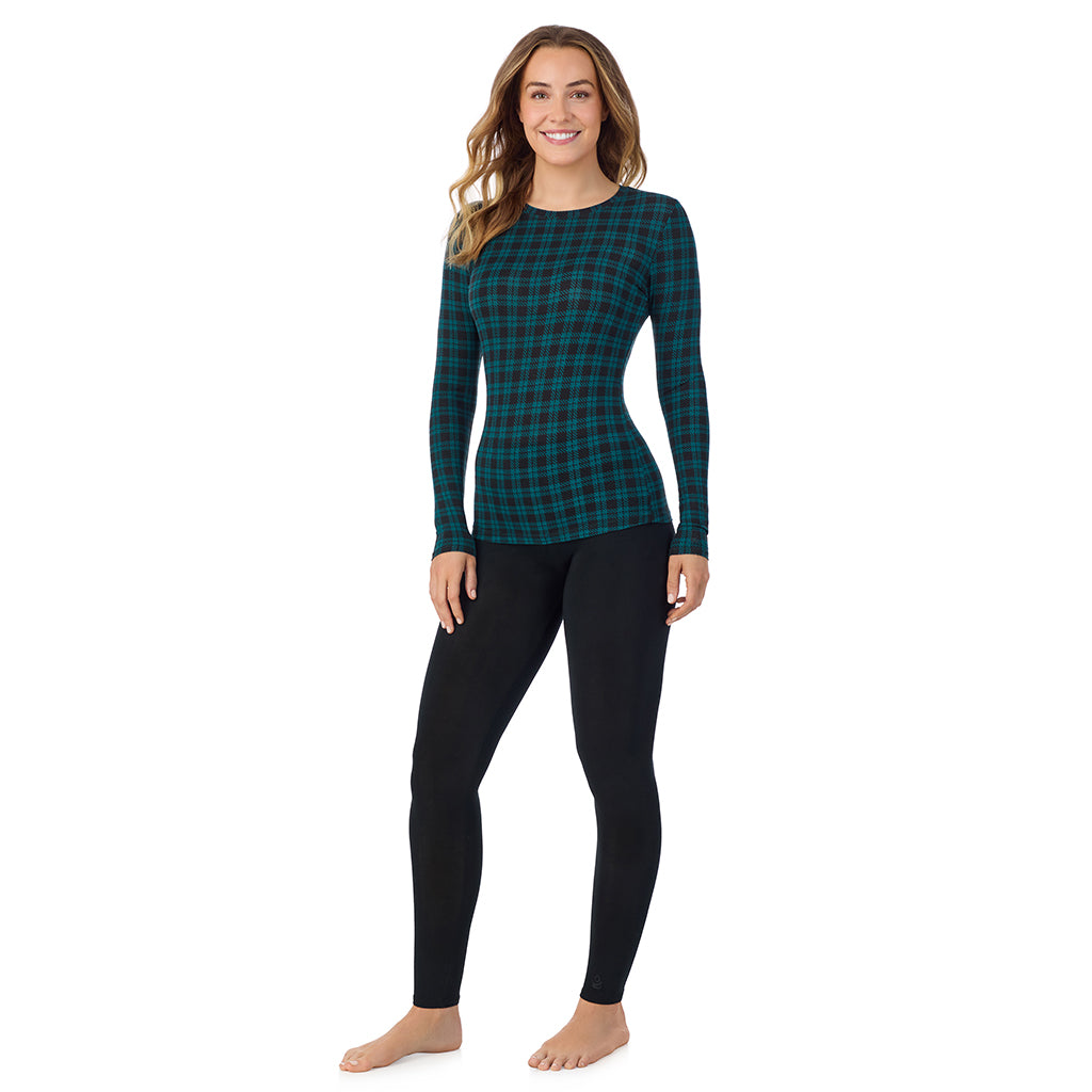 A lady wearing a dk pine/black plaid long sleeve stretch crew.