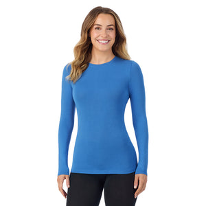 A lady wearing a blue comet long sleeve stretch crew.