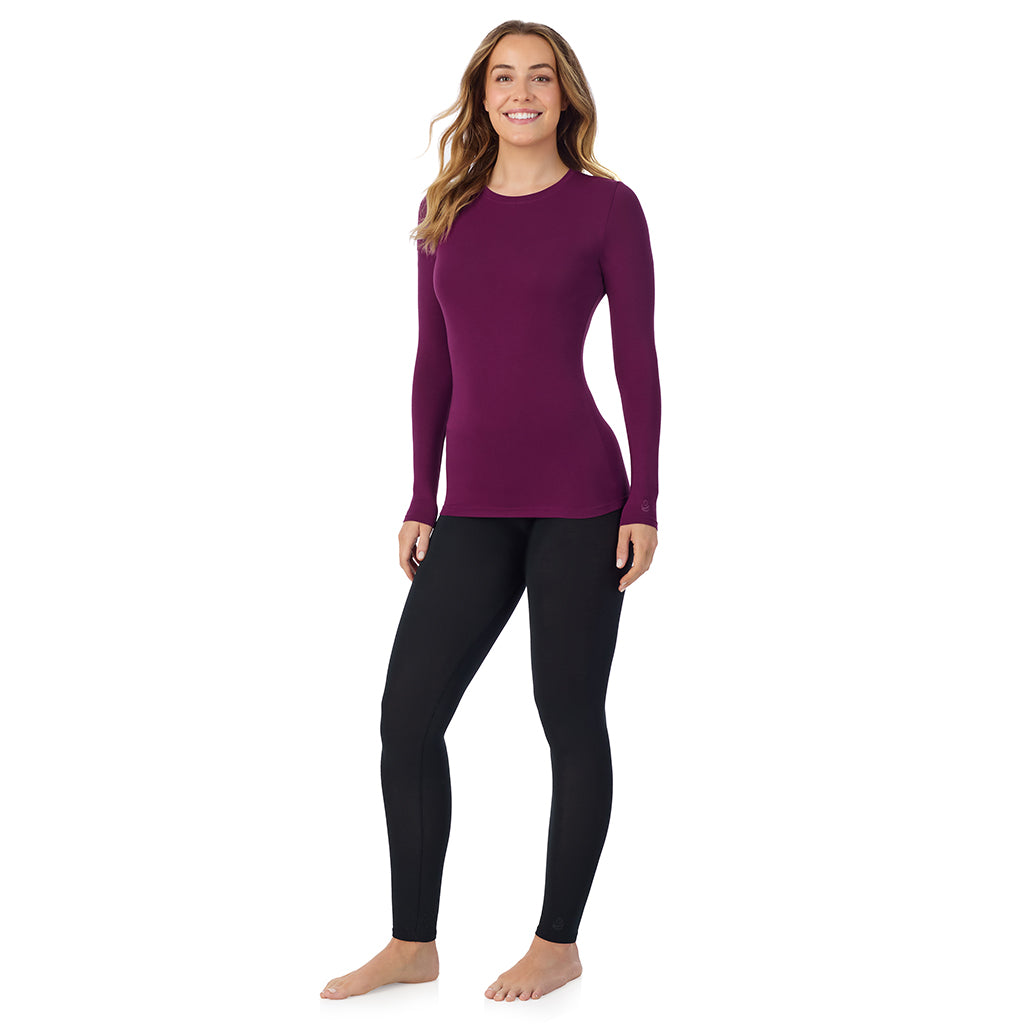 A lady wearing a dark purple long sleeve stretch crew.
