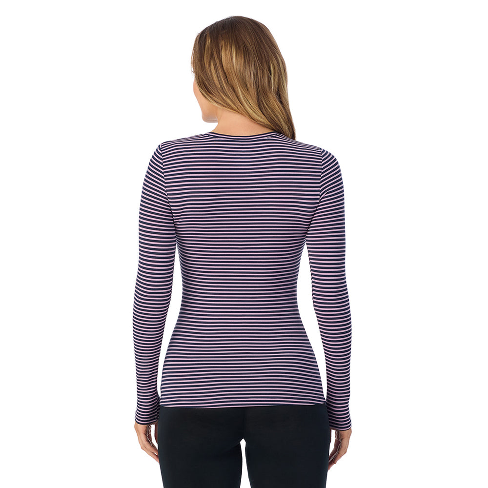 A lady wearing a mauve/navy stripe long sleeve stretch crew.