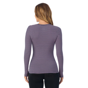 A lady wearing a mauve/navy stripe long sleeve stretch crew.