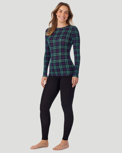 A lady wearing a Blackwatch Plaid long sleeve stretch crew. 