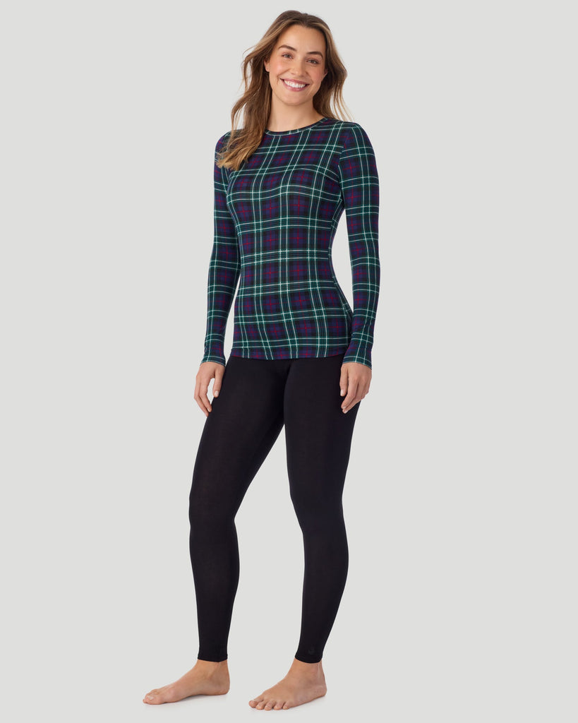 A lady wearing a Blackwatch Plaid long sleeve stretch crew. 