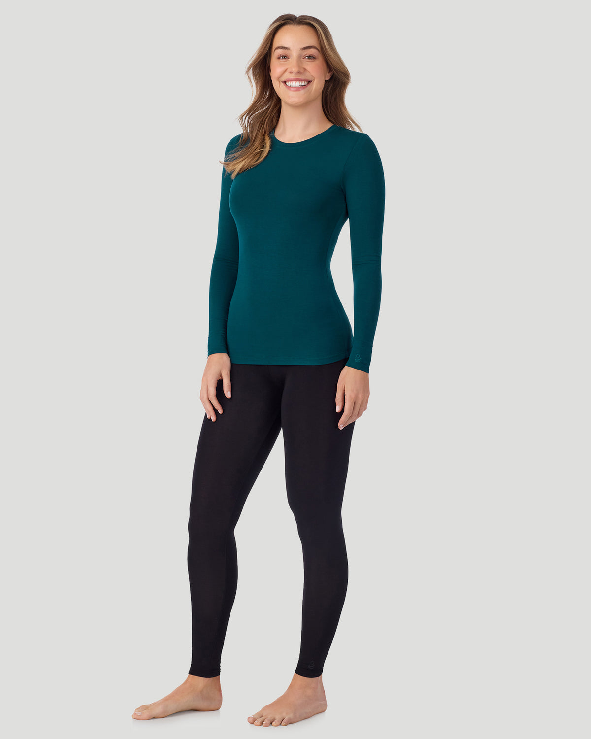 Deep Emerald ; Model is wearing a size S. She is 5’11.5”, Bust 34”, Waist 27”, Hips 38.5”. @A lady wearing Softwear With Stretch Long Sleeve Crew PETITE in Deep Emerald in a front view standing pose