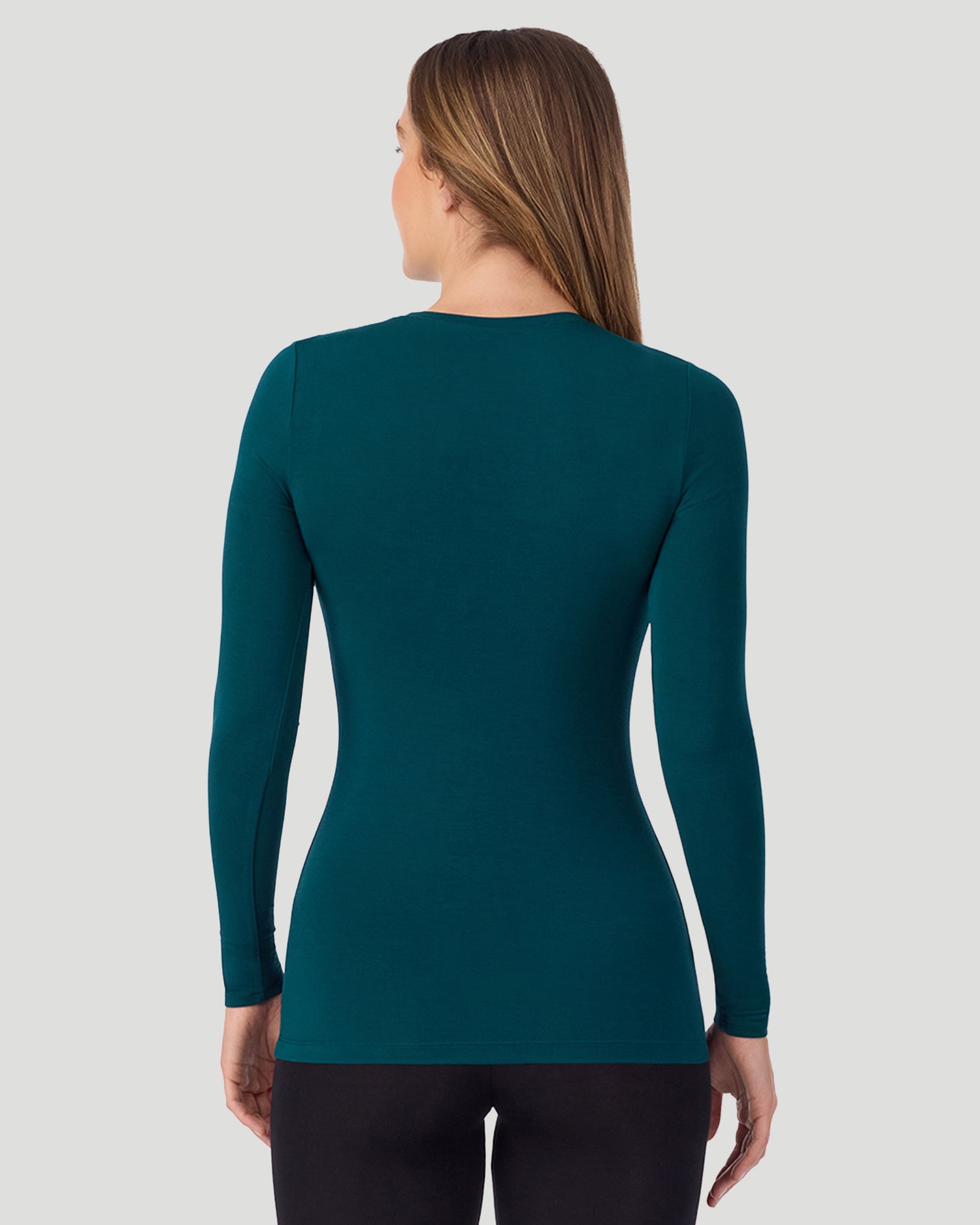 A lady wearing Softwear With Stretch Long Sleeve Crew PETITE in Deep Emerald in a back view pose