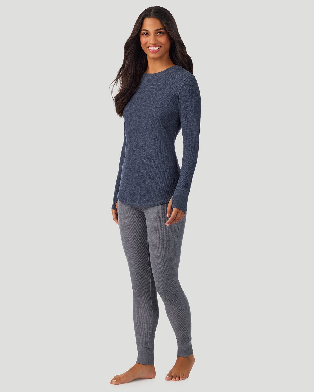 A lady wearing Medieval Blue Heather Cozy Stretch Thermal Long Sleeve Crew in a front view standing pose