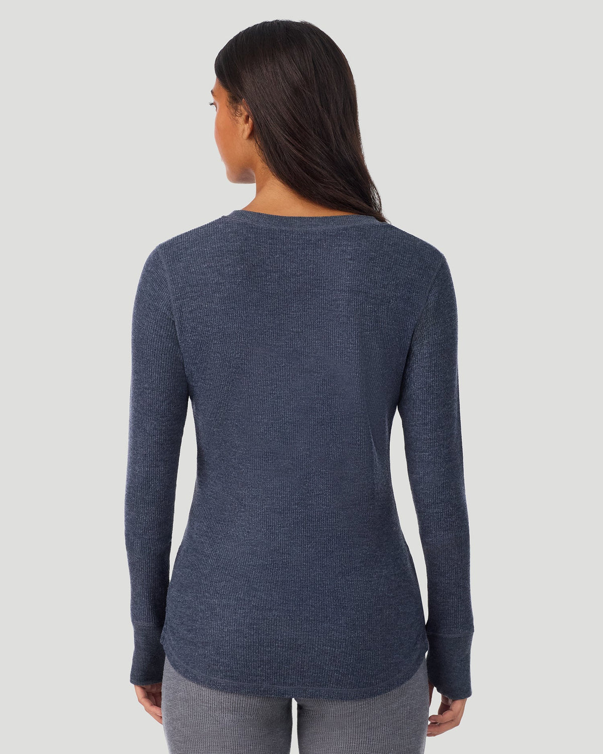 A lady wearing Medieval Blue Heather Cozy Stretch Thermal Long Sleeve Crew in a back view pose