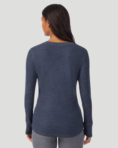 A lady wearing Medieval Blue Heather Cozy Stretch Thermal Long Sleeve Crew in a back view pose