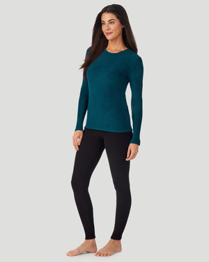 A lady wearing Deep Emerald Fleecewear with Stretch Long Sleeve Crew in a front view standing pose