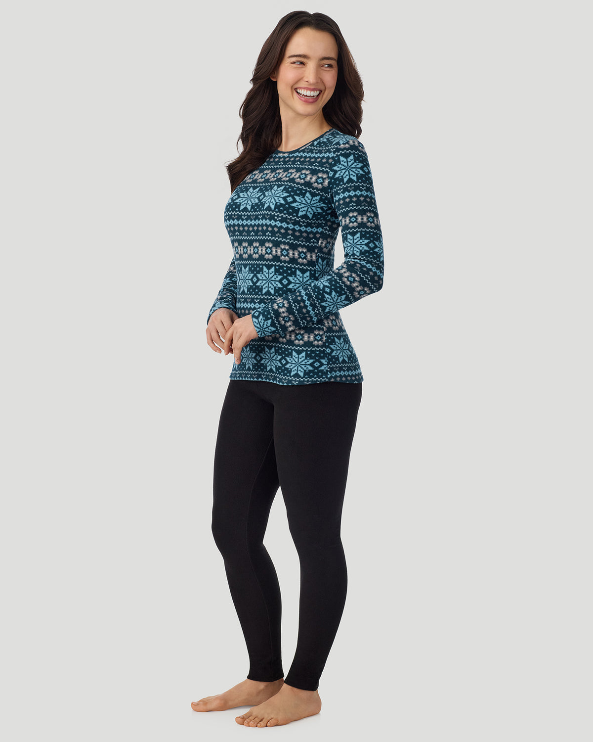 Emerald Fairisle; Model is wearing a size S. She is 5’9.5”, Bust 34”, Waist 25”, Hips 36.5”. @A lady wearing Emerald Fairisle Fleecewear with Stretch Long Sleeve Crew in a front view standing pose