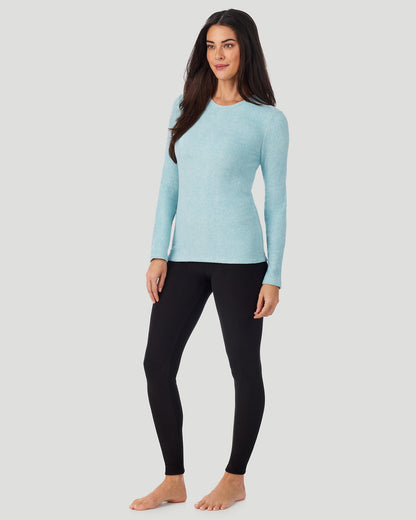 A lady wearing Cadet Blue Heather Fleecewear with Stretch Long Sleeve Crew in a front view standing pose