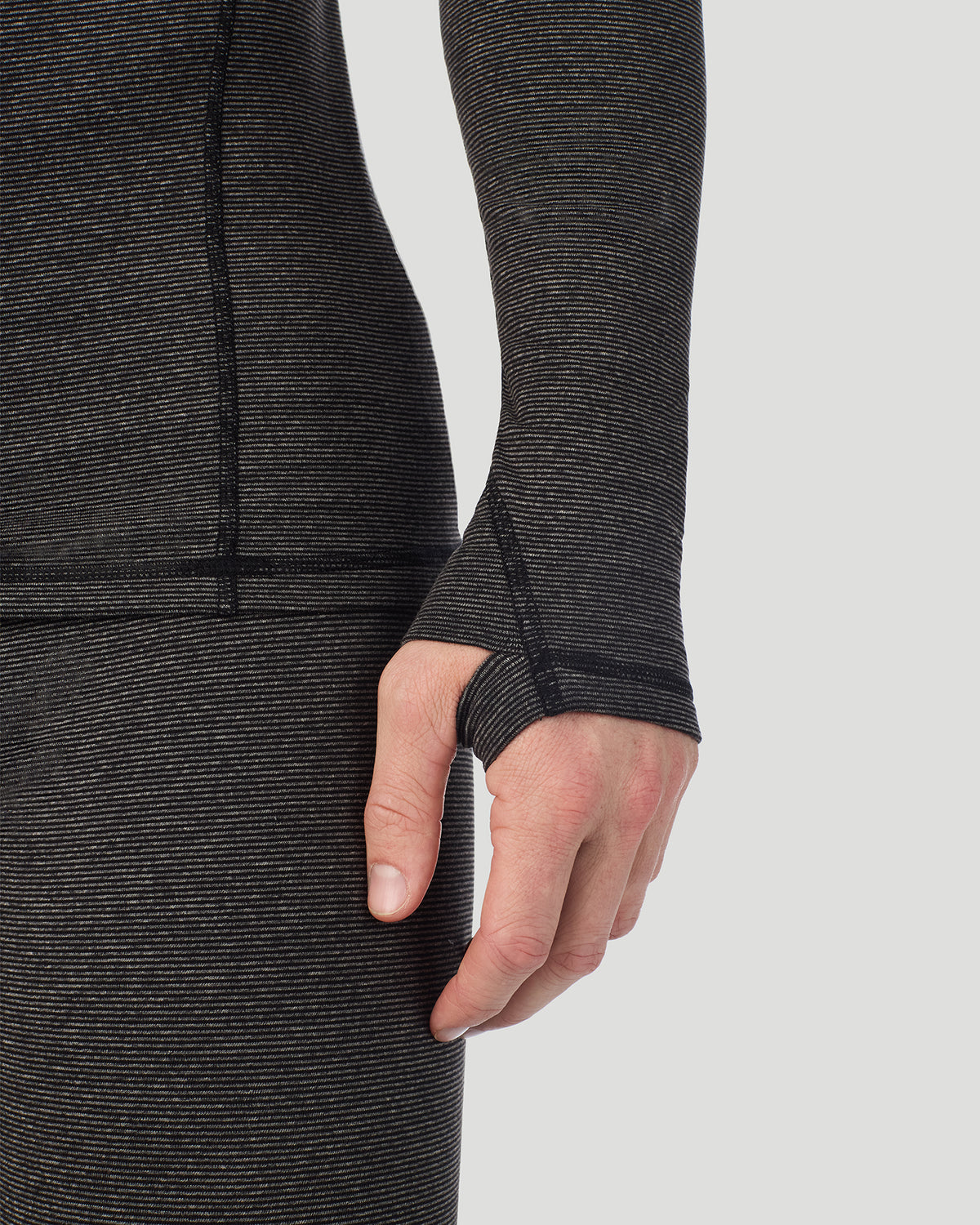  A man wearing Grey Stripe FlexStripe Long Sleeve Crew in a front view detail close up look of the sleeve thumbhole