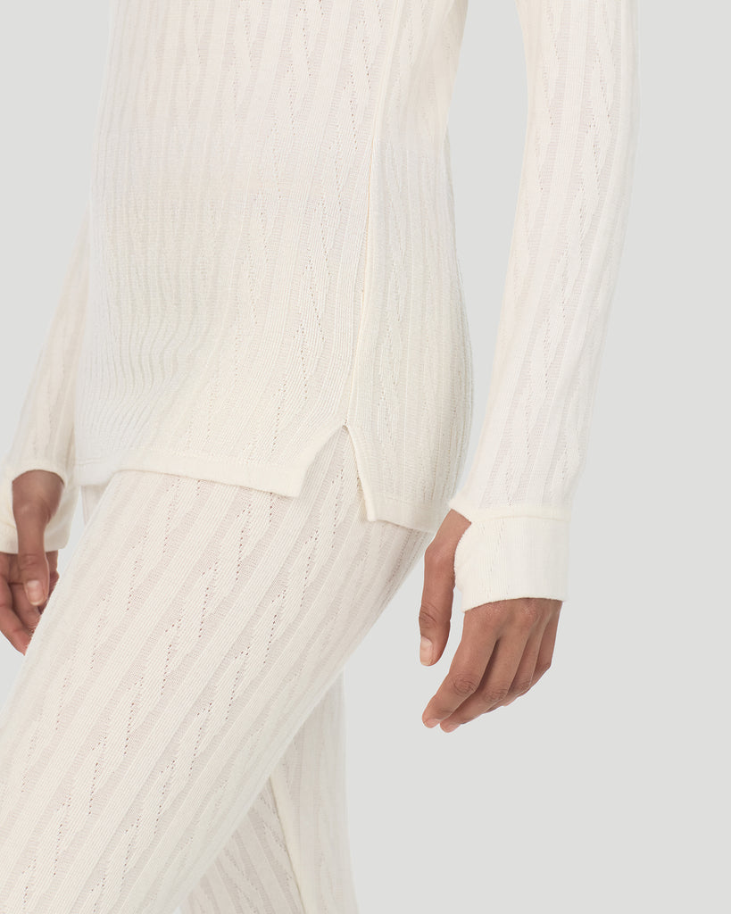 A lady wearing Vanilla Ice Cable Knit Long Sleeve Crew in a front view detail close up look