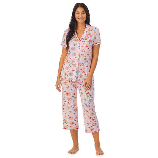 A lady wearing pink short sleeve notch collar pj set with pancake print