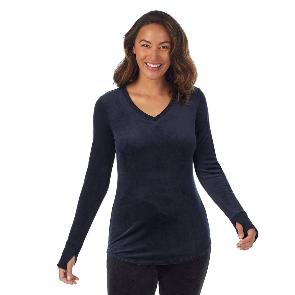 A lady wearing blue stretch velour long sleeve v-neck