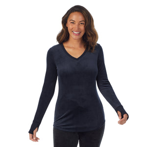 A lady wearing blue stretch velour long sleeve v-neck