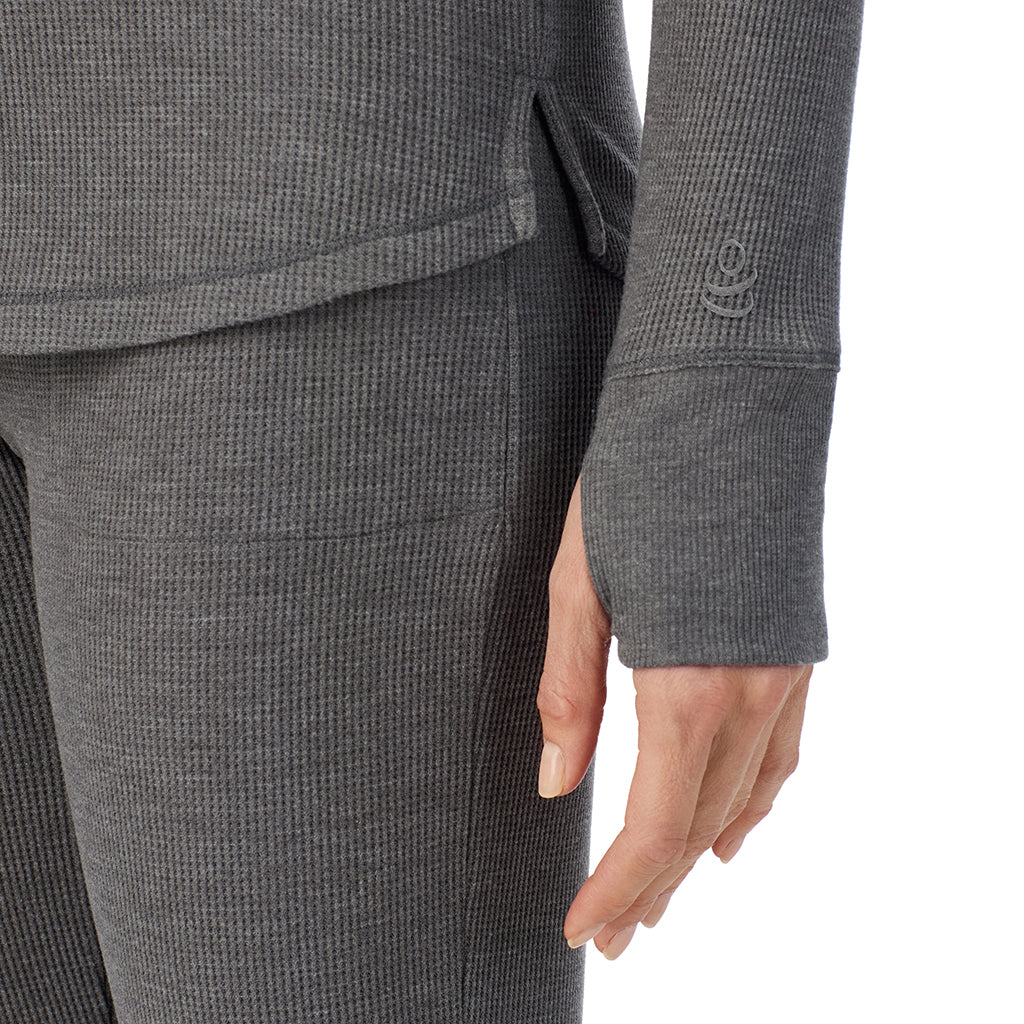  A lady is wearing a stone grey heather Cozy Stretch Thermal Long Sleeve Mock Neck