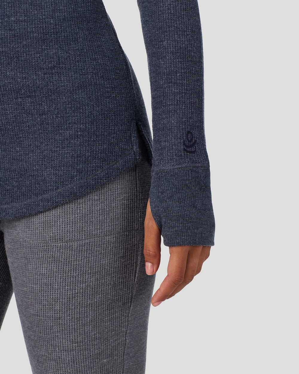 A lady wearing Medieval Blue Heather Cozy Stretch Thermal Long Sleeve Mock Neck in a front view detail close up look